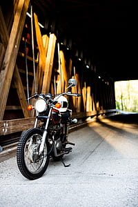 motorcycle parks under tunnel bridge thumbnail