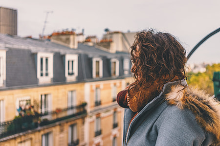 woman wearing coat standing on rooftop thumbnail
