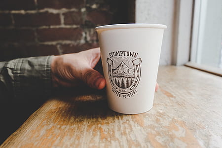 person holding white disposable cup thumbnail