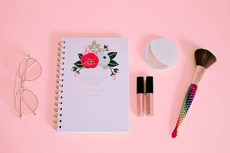 Flat lay Photography of Notebook Near Eyeglasses and Make-up thumbnail
