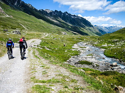 two mountain bikers near water stream thumbnail