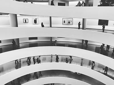 round white multi-layer building with lots of people indoors thumbnail