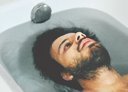 man on white bathtub during daytime thumbnail