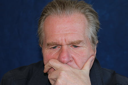 man thinking while his hand on his face thumbnail