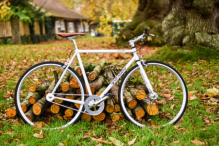 white road bike beside firewood thumbnail
