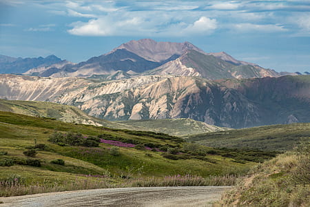 brown mountain under blue and white sky thumbnail