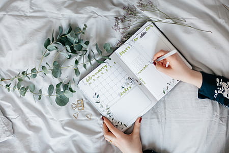 person writing on book page thumbnail
