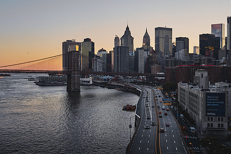 aerial photography of high rise building near bridge during daytime thumbnail