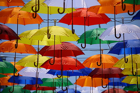 multicolored umbrellas flying on sky during daytime thumbnail