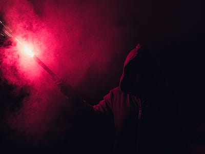 Hooded Figure Holding Red Flare thumbnail