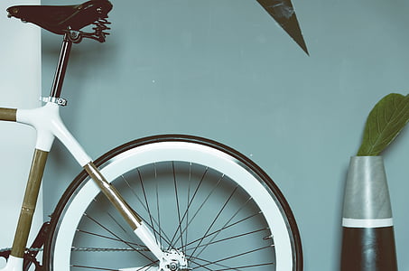 brown and white bicycle beside a gray and brown vase thumbnail