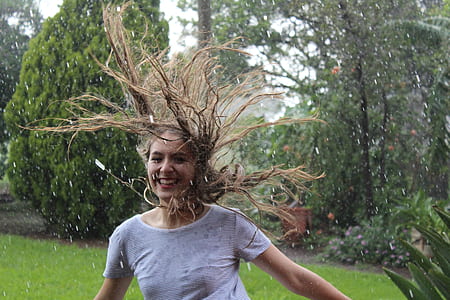 woman in gray shirt near green leafed trees thumbnail