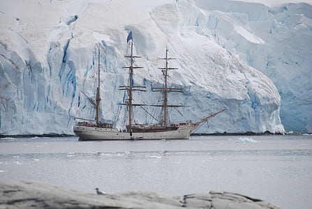 white ship on body of water near ice berg at daytime thumbnail