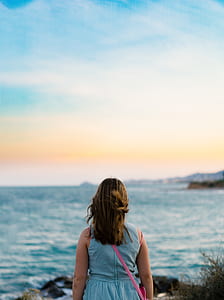 woman facing ocean thumbnail