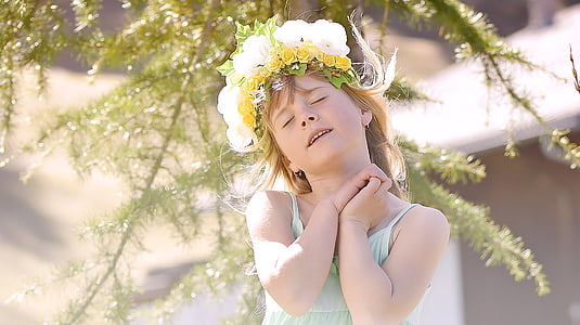 selective focus photography of girl wearing flower crown under tree at daytime thumbnail