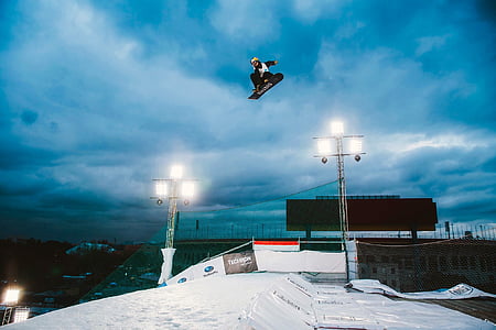 person riding snowboard on mid air thumbnail