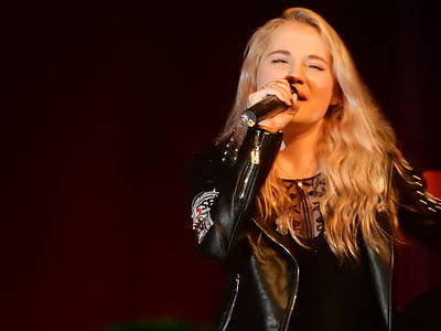 woman in black leather blazer singing thumbnail
