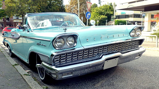 classic teal coupe parked on road thumbnail