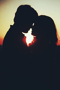 Silhouette Photo of Man and Woman About to Kiss thumbnail