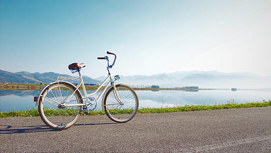 Gray Commuter Bike Parked on Road Beside Sea thumbnail