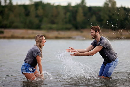 Man and Woman Playing on Body of Water thumbnail