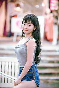 woman in gray spaghetti strap top and blue shorts thumbnail