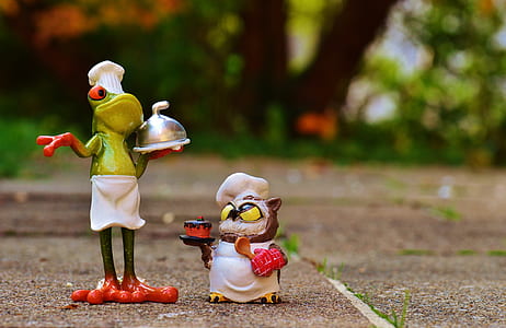 frig chef beside owl chef carrying cake figurines on gray surface thumbnail