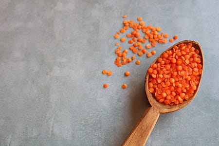 Red lentils in a wooden spoon thumbnail