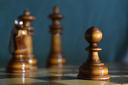 selective focus photography of brown pawn chess piece thumbnail