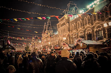 crowd of people infront of lighted building thumbnail