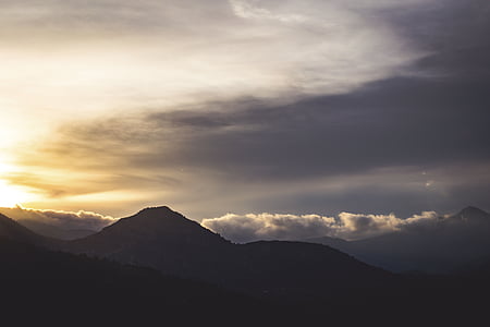 silhouette of mountain under white sky thumbnail