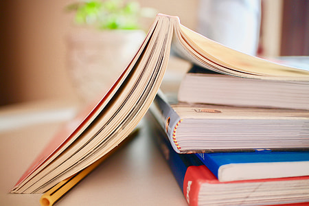 selective focus photo of softbound books on white surface thumbnail