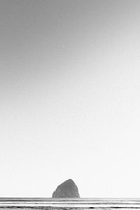 grayscale photo of stone on body of water at daytime thumbnail