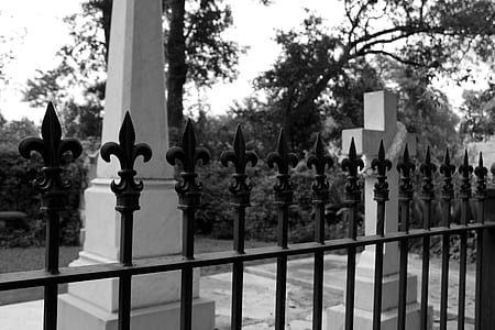 black metal fence near cross statue thumbnail