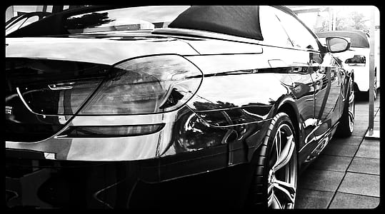 grayscale photography of sedan on road thumbnail