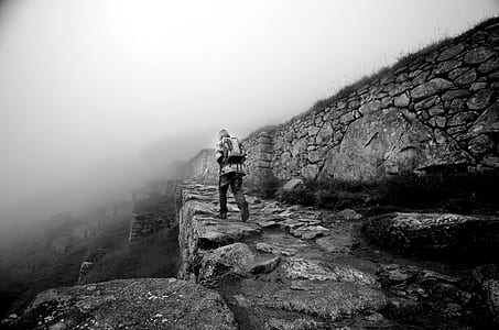 person hiking up mountain grayscale photo thumbnail