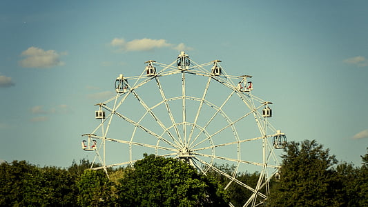 photo of white Ferris wheel under blue sky background thumbnail