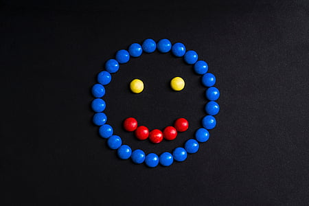 red, yellow, and black smiling emoji on black surface thumbnail