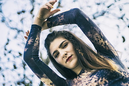 Low Angle Photo of Woman Raising Her Hands thumbnail