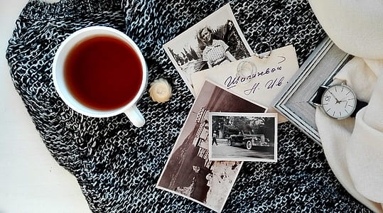flat lay photography of cup and picture on mat thumbnail