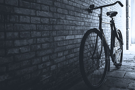 Bicycle stands by a wall in the city thumbnail
