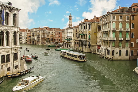 two white boats on body of water near building thumbnail