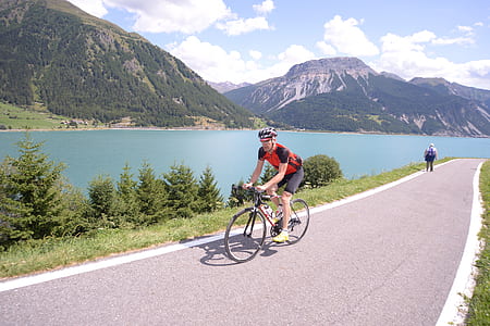 cyclist riding beside green grass thumbnail