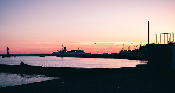 Silhouette of Boat Dock Near Water during Dawn thumbnail