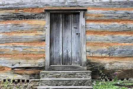 close-up of grey wooden door on brown wooden wall thumbnail
