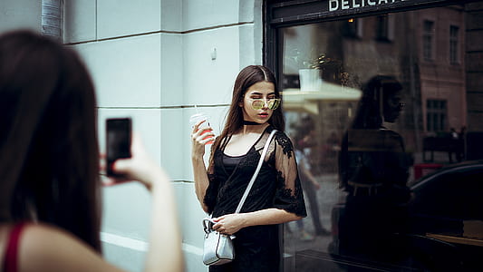 woman in black dress in front of glass wall in fashion photography thumbnail