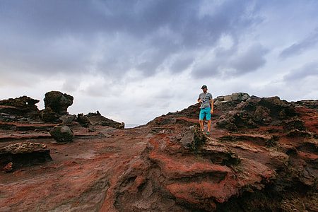man standing near rocks thumbnail
