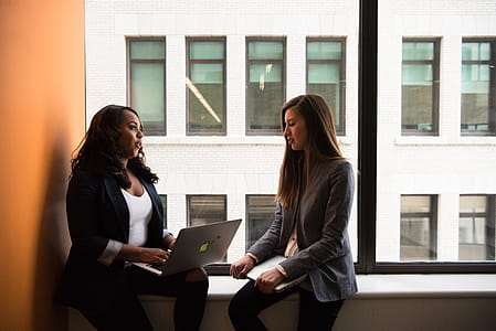 Woman Holding Laptop Computer Near Window thumbnail