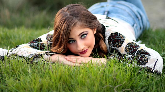 woman lying on grass field thumbnail