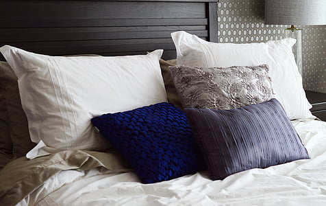 assorted-color pillows on bed thumbnail